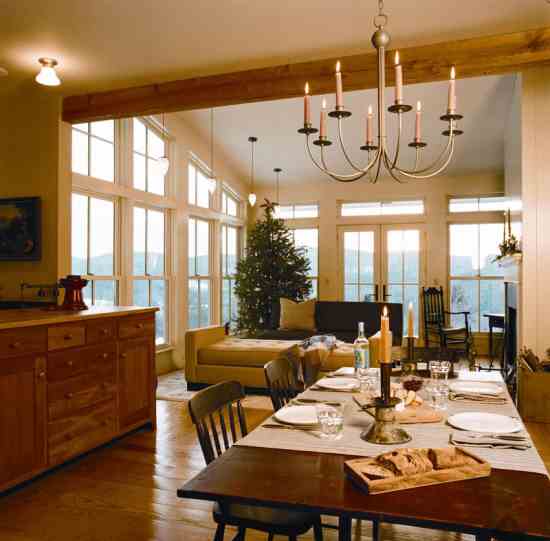 “Cathy and I agreed we wanted a living room, dining room and kitchen that flowed together, even though it’s not a historically accurate floorplan,” Michele says. Architect Dennis Wedlick created this open space with a ceiling that slants from 13 feet to 9 feet. Insulated, double-glazed windows and French doors let the couple appreciate views in a way upstate New Yorkers never could have 200 winters ago. Dramatic nighttime lighting is provided by a non-electric “candelier” over the dining room table and pendant lights made from rewired Victorian gas lampshades.